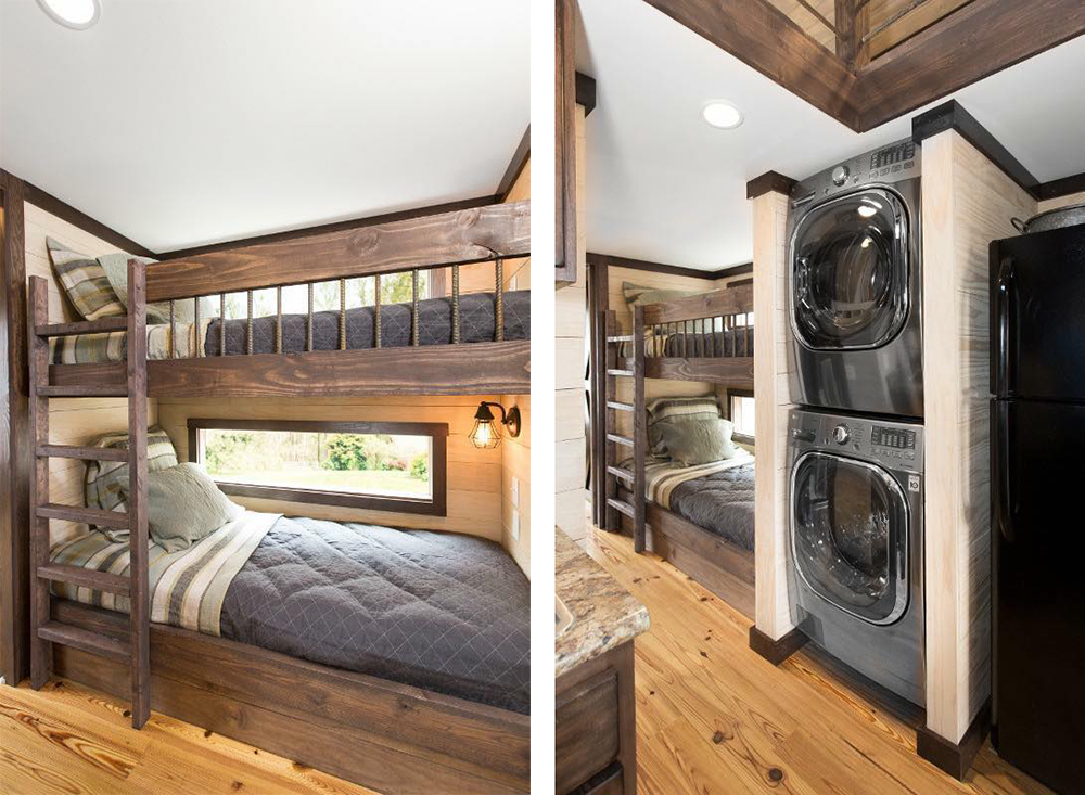 Cozy room with wooden bunk beds, plaid pillows, and a soft, quilted gray comforter. Adjacent is a stacked washer-and-dryer unit and a small kitchen area, all with a warm, rustic ambiance.