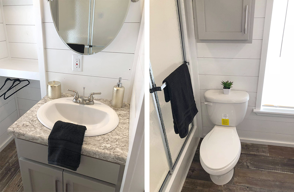 Compact modern bathroom with gray cabinetry. Left: Oval mirror over sink with soap dispenser and black towel. Right: Toilet with plant, shower, and towel.