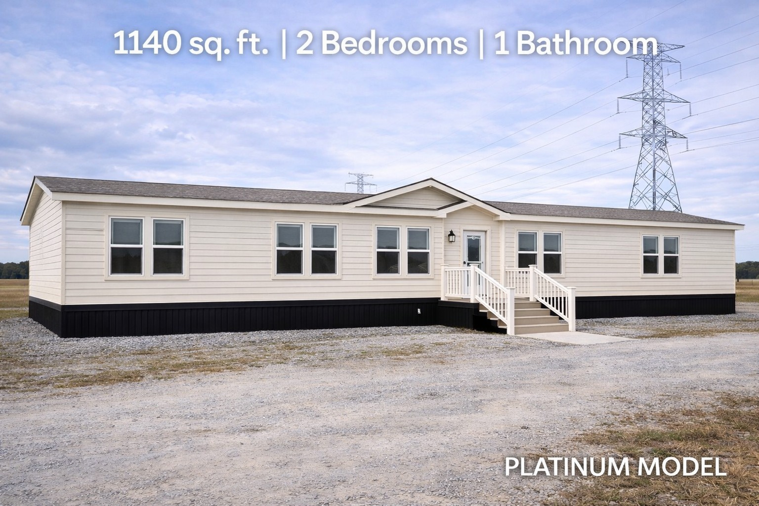 Single-story beige manufactured home with a white porch, set in a rural area. Text above reads "1140 sq. ft. | 2 Bedrooms | 1 Bathroom."