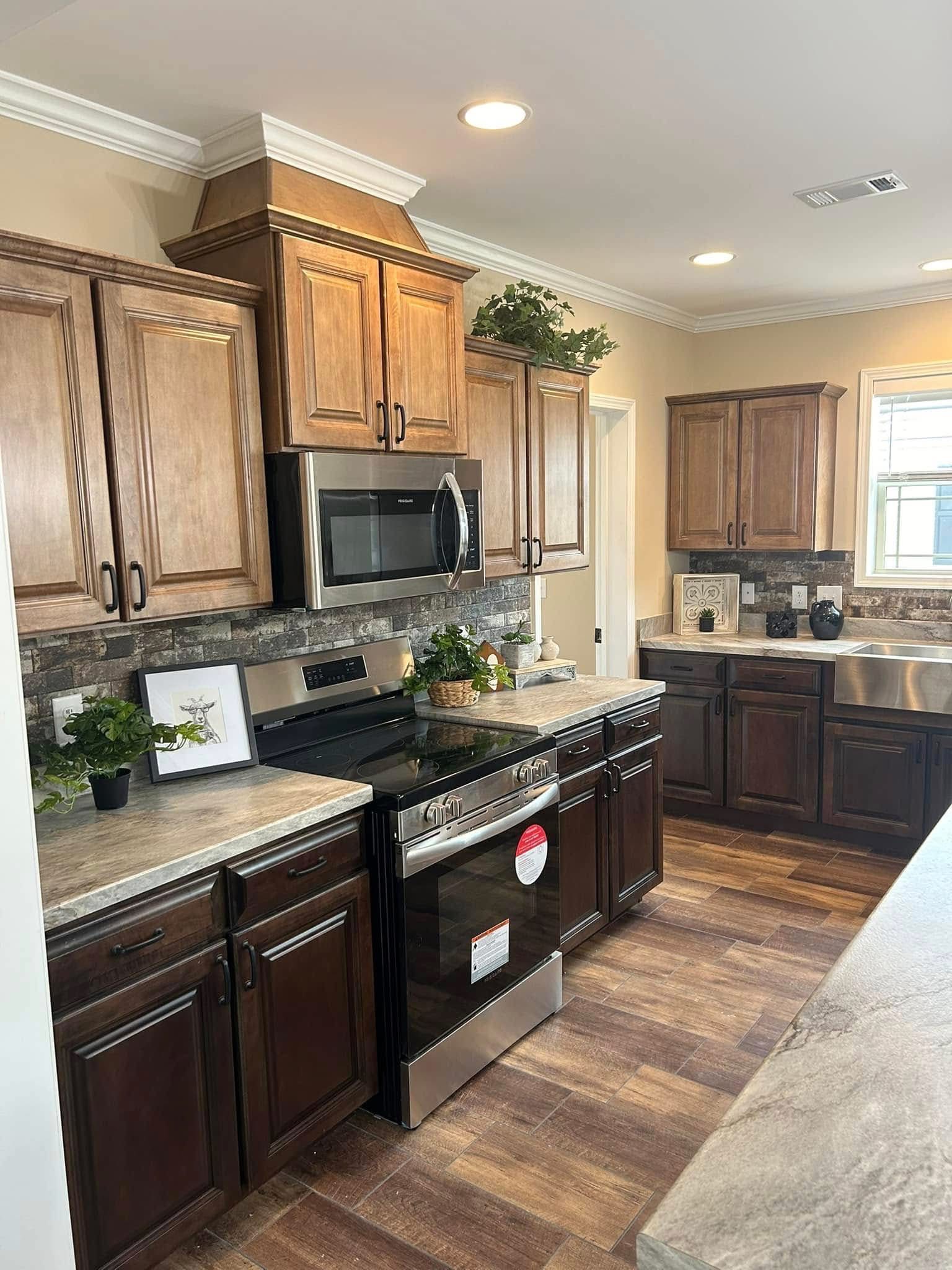 Warm-toned kitchen with dark wood cabinets, stainless steel appliances, and stone backsplash. Plants and decor add a welcoming, stylish touch.