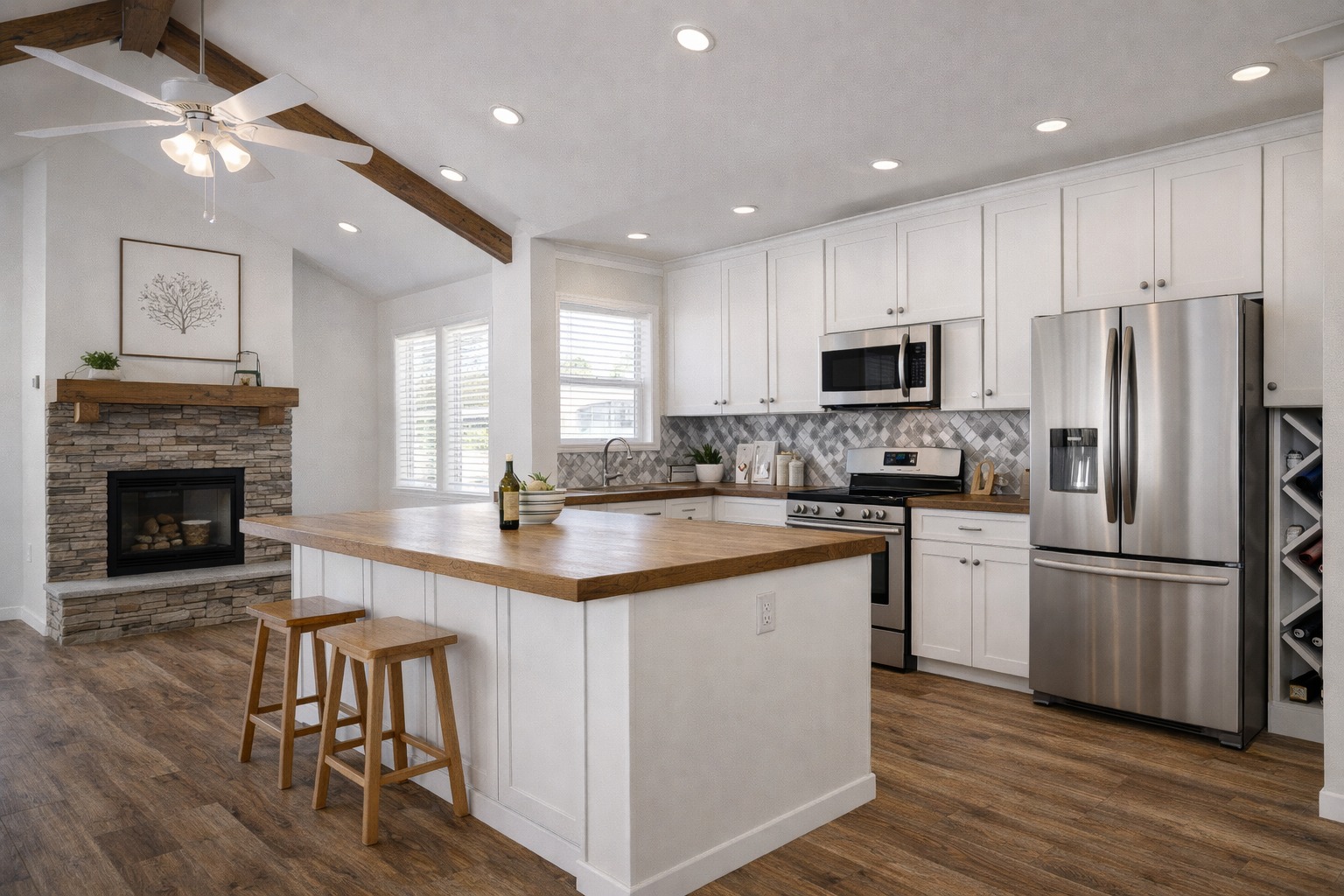 Modern kitchen with white cabinets, wood countertops, stainless steel appliances, and herringbone backsplash. Cozy living space with fireplace and natural light.
