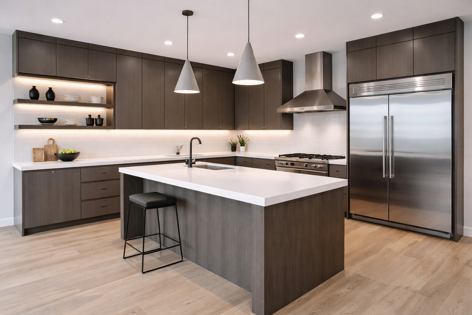 Modern kitchen with dark wood cabinets, white countertops, stainless steel appliances, and pendant lights. Island with seating on wood floors creates a sleek, inviting space.