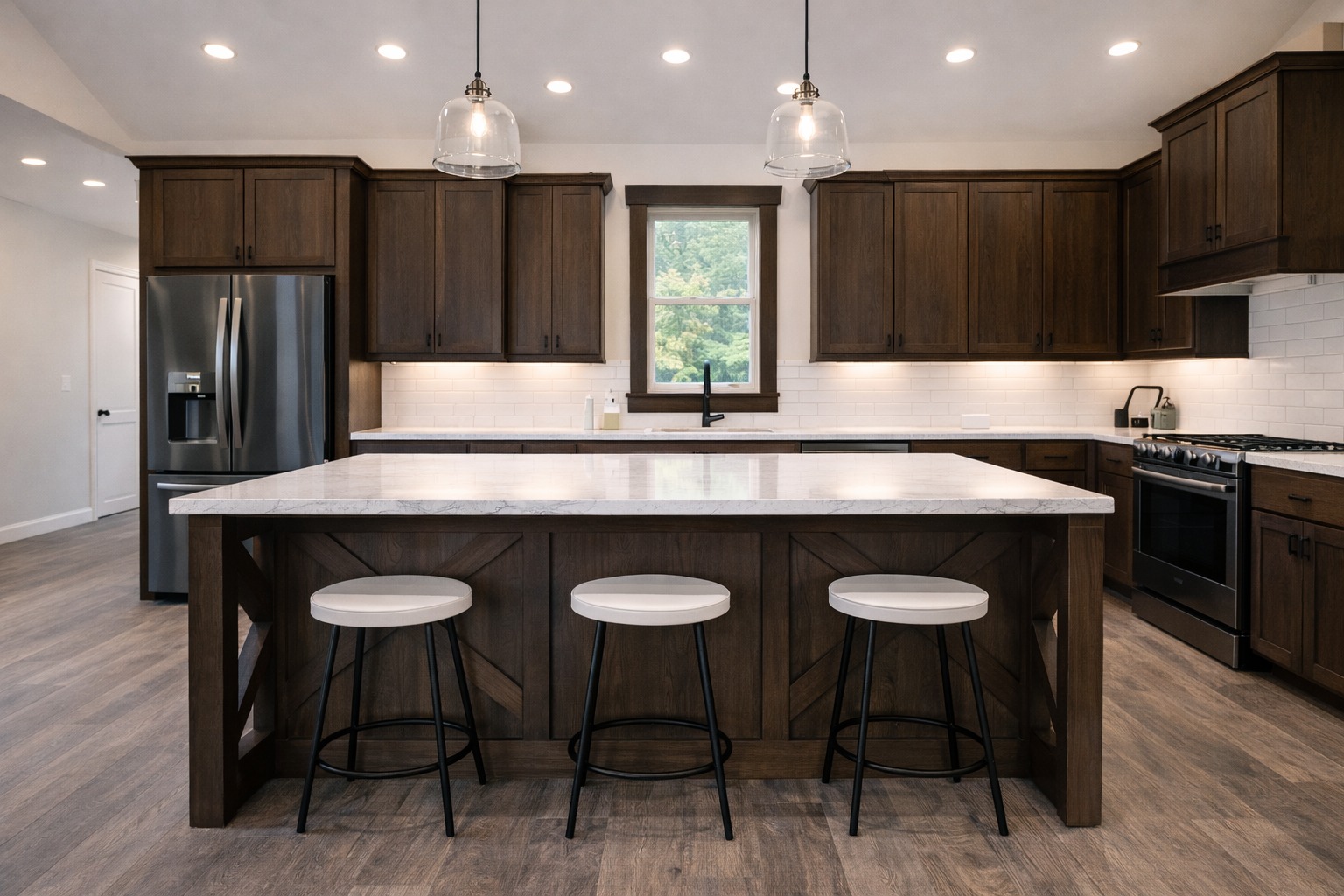 Modern kitchen with dark wood cabinets, marble island, and three stools. Pendant lights hang above. Stainless steel appliances and a window view. Warm, inviting tone.