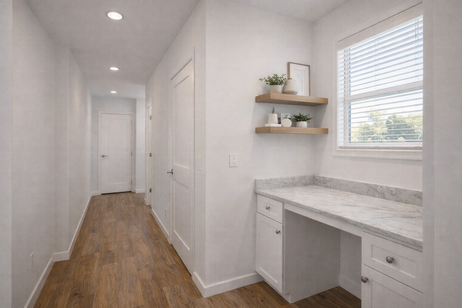Bright hallway with white walls and wooden floor. Features a small desk with marble top, two shelves with decor items, and a window with blinds. Calm and minimalist.