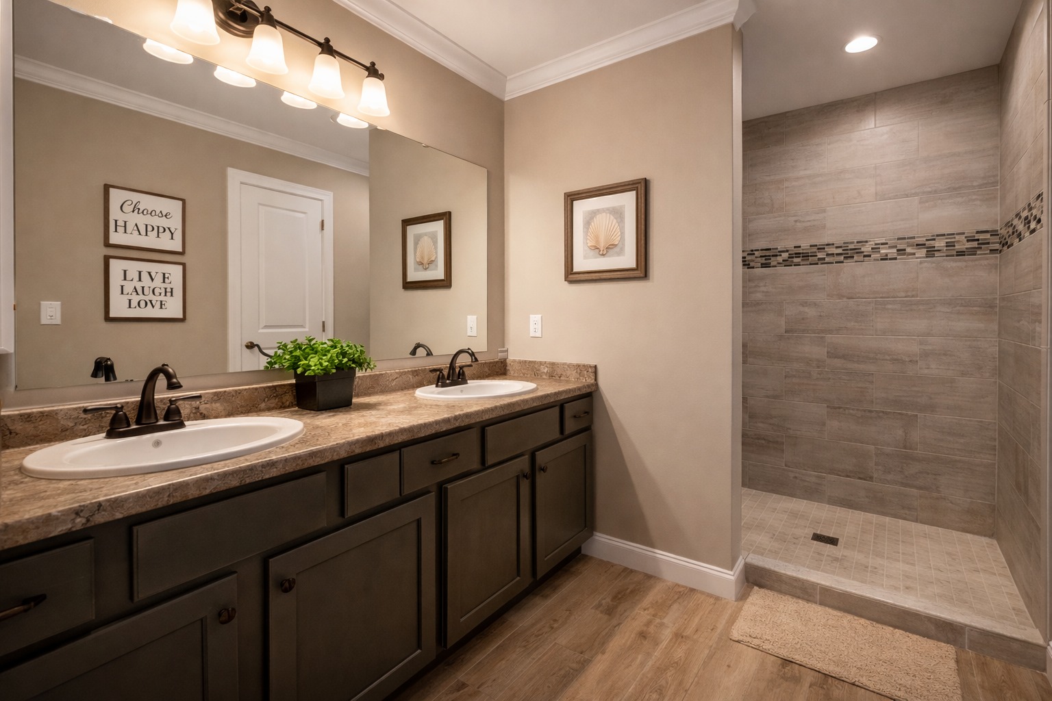 Modern bathroom featuring a double sink with dark wood cabinets, a large mirror, and a walk-in shower. Soft lighting and neutral tones create a calm atmosphere.