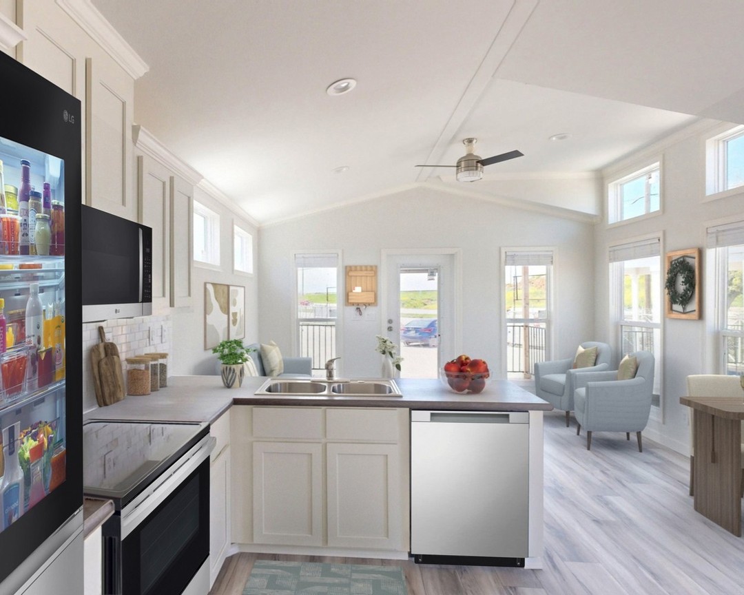 Spacious modern kitchen with light cabinetry, stainless steel appliances, and a bowl of red apples. Bright, airy living area with large windows and cozy seating.