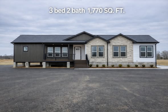 Single-story gray modular home with a front porch, three windows, and white stone accents. Text above reads "3 bed 2 bath 1,770 SQ. FT."