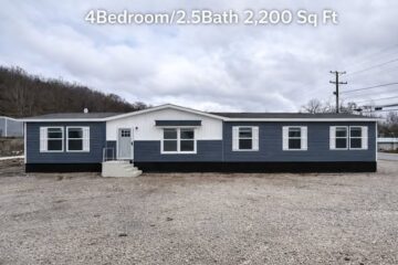 Single-story, blue and white house with modern design, showing multiple windows. Text reads "4 Bedroom/2.5 Bath 2,200 Sq Ft." Cloudy sky backdrop.