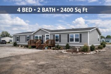 Single-story gray manufactured home with a small wooden deck, surrounded by sparse landscaping. Text overlay: "4 BED • 2 BATH • 2400 Sq Ft."
