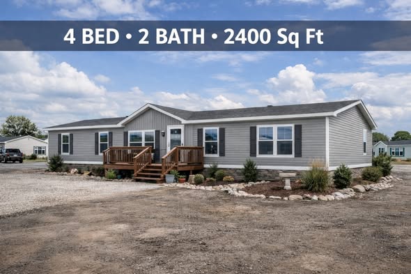 Single-story gray manufactured home with a small wooden deck, surrounded by sparse landscaping. Text overlay: "4 BED • 2 BATH • 2400 Sq Ft."