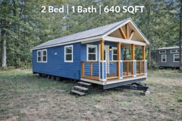 Charming tiny blue house with front porch, white trim, and wooden railings, set in a wooded area. Text above reads "2 Bed | 1 Bath | 640 SQFT."