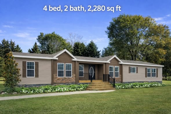 Single-story home with beige siding and brick accents, surrounded by trees and lawn, featuring four bedrooms and two bathrooms. Bright, serene setting.