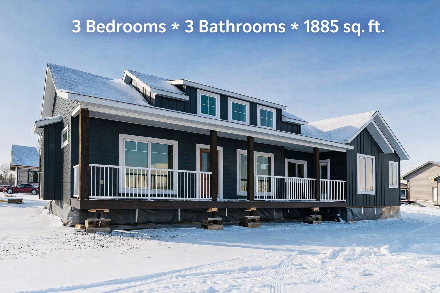 A modern blue-gray house on a snowy landscape, featuring a white-railed porch and slanted roof. Text overlay: "3 Bedrooms, 3 Bathrooms, 1885 sq. ft."