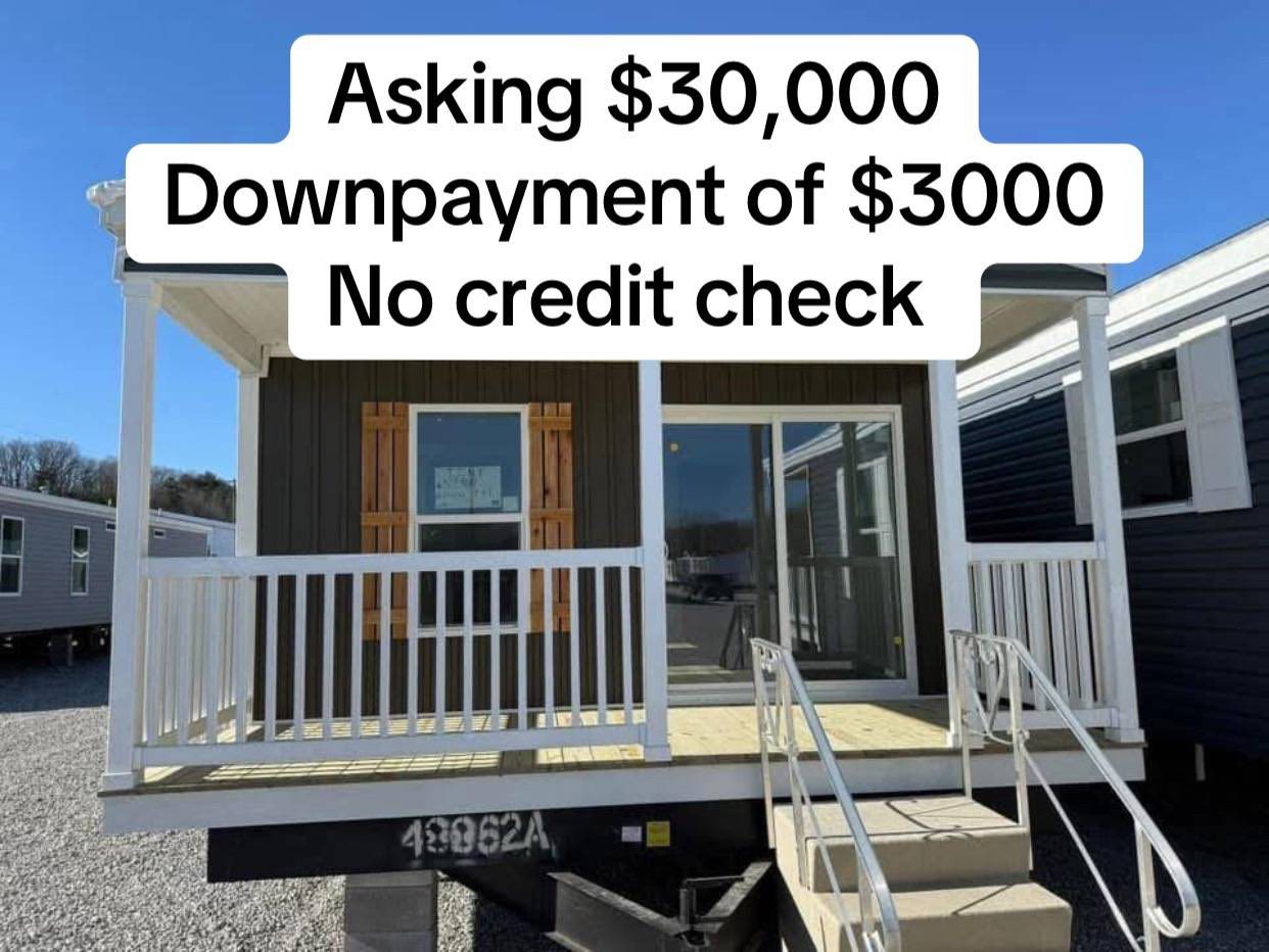 A small, brown mobile home with a white front porch and stairs. Overlay text reads, "Asking $30,000, Downpayment of $3000, No credit check."