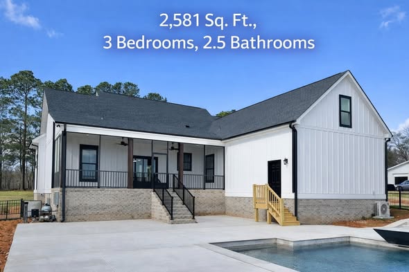 A modern white house with gray roof, featuring a porch, black railings, and adjacent pool. Text reads: "2,581 Sq. Ft., 3 Bedrooms, 2.5 Bathrooms."