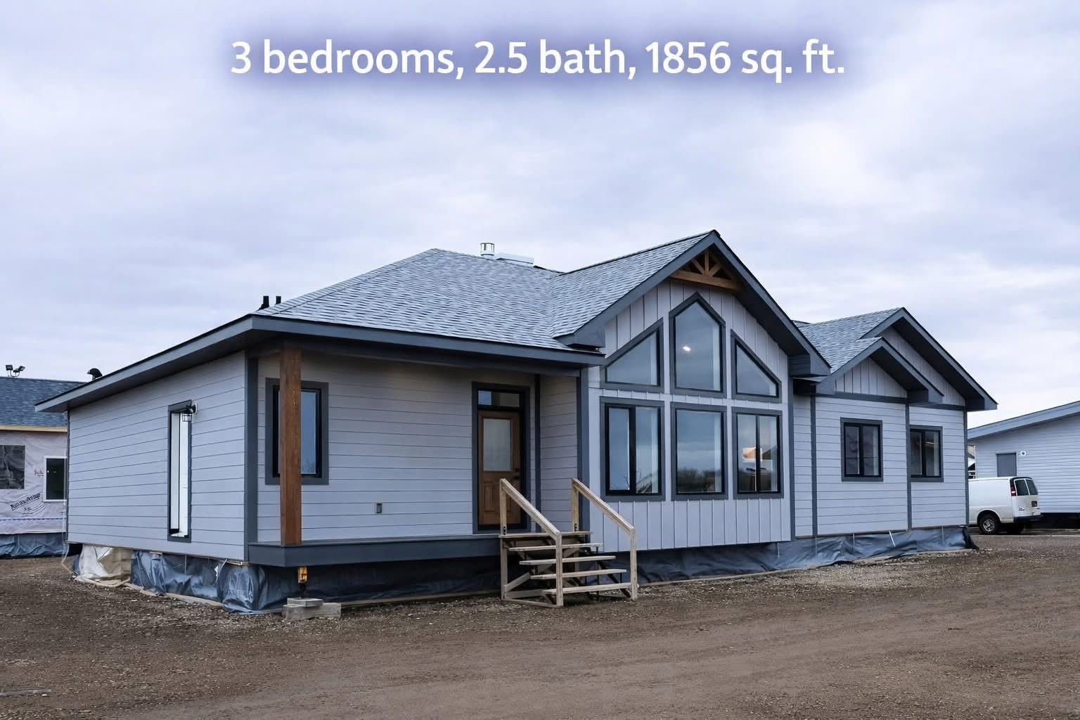 Single-story modern house with gray siding, large windows, and pitched roof. Text overlay states: "3 bedrooms, 2.5 baths, 1856 sq. ft." Emphasizes simplicity.