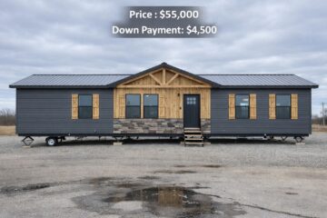 Single-story modular home with gray siding and wooden accents set on a gravel lot, priced at $55,000 with a $4,500 down payment, under overcast skies.