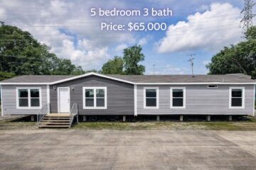 A gray and white modular home with five windows and a single front door, set against a backdrop of trees and a blue sky. Text reads "5 bedroom 3 bath, Price: $65,000."