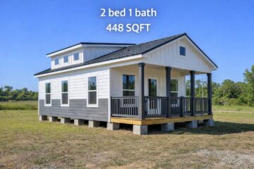 Small house with white siding and dark trim, featuring a front porch. Text reads: "2 bed 1 bath, 448 SQFT." Blue sky and grassy field in background.