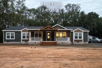 A modern, single-story house with a dark exterior, white trim, and a welcoming porch, set against a backdrop of tall trees. Text overlay reads "4 bed 3 bath, 2,400 SQFT."