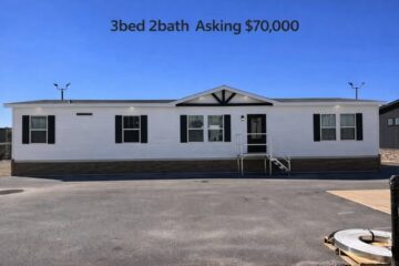 A manufactured home with a white exterior, black shutters, and a small porch. Text above reads "3bed 2bath Asking $70,000" against a clear blue sky.