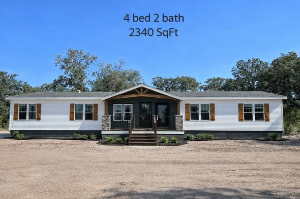 A single-story white house with a wooden porch, surrounded by trees. Text above reads "4 bed 2 bath, 2340 SqFt." The setting is sunny and peaceful.