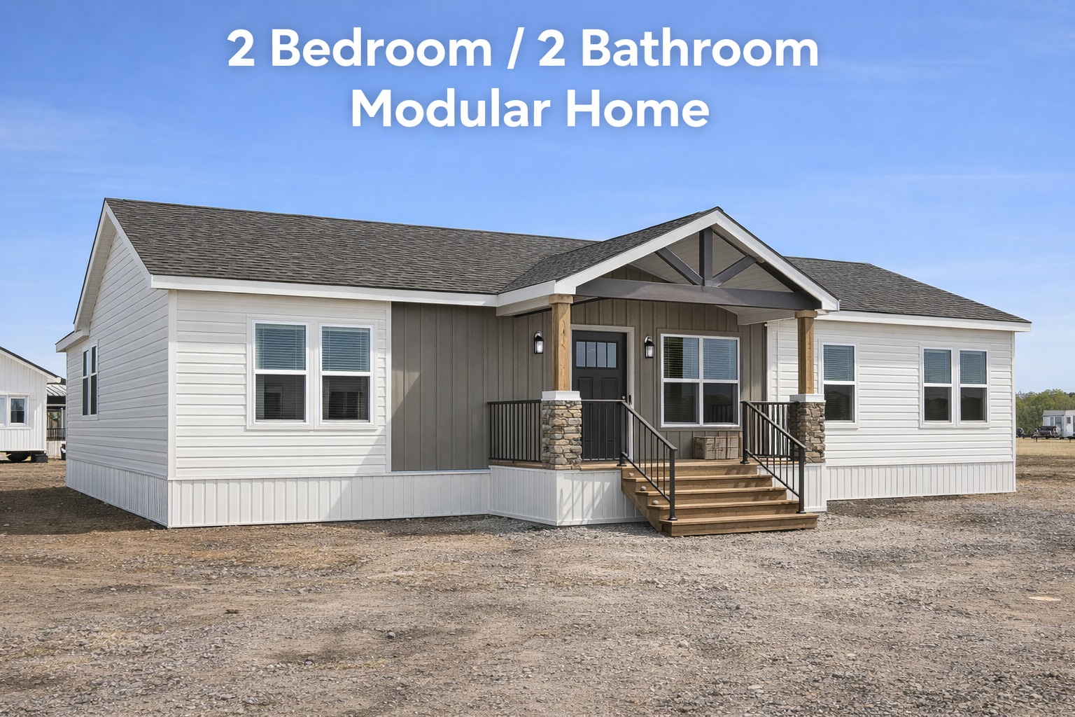 Front view of a modern, beige and white modular home with a peaked roof, two large front windows, small porch with stairs, set on a gravel lot.