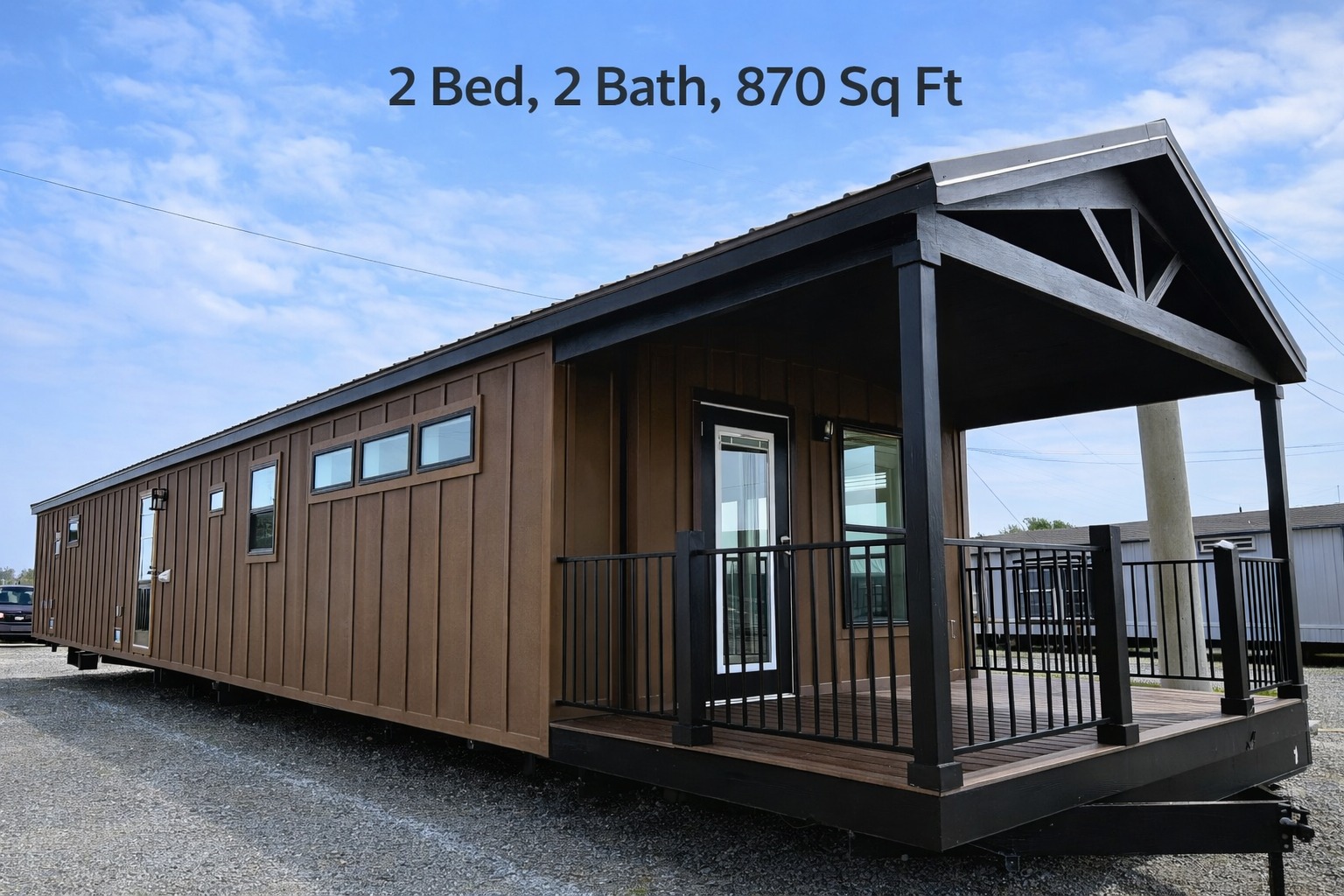 A modern brown tiny house with a porch sits on gravel under a blue sky. Text above reads "2 Bed, 2 Bath, 870 Sq Ft."