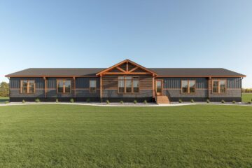 Spacious one-story house with wood accents and a gabled roof, surrounded by lush green lawn under a clear blue sky.