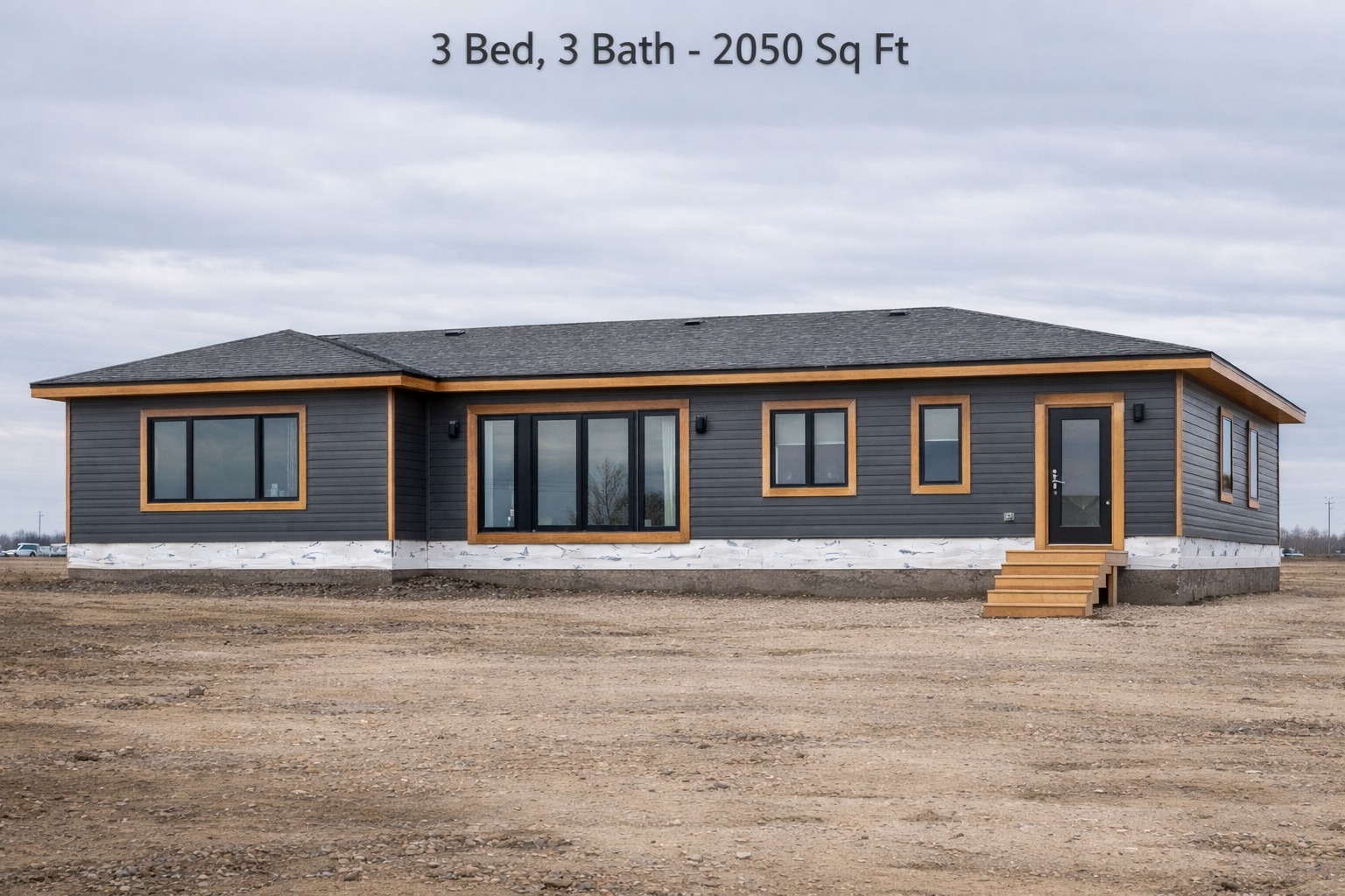 Single-story gray house with large windows and a wooden trim, set on bare land under a cloudy sky. Text above reads: "3 Bed, 3 Bath - 2050 Sq Ft."