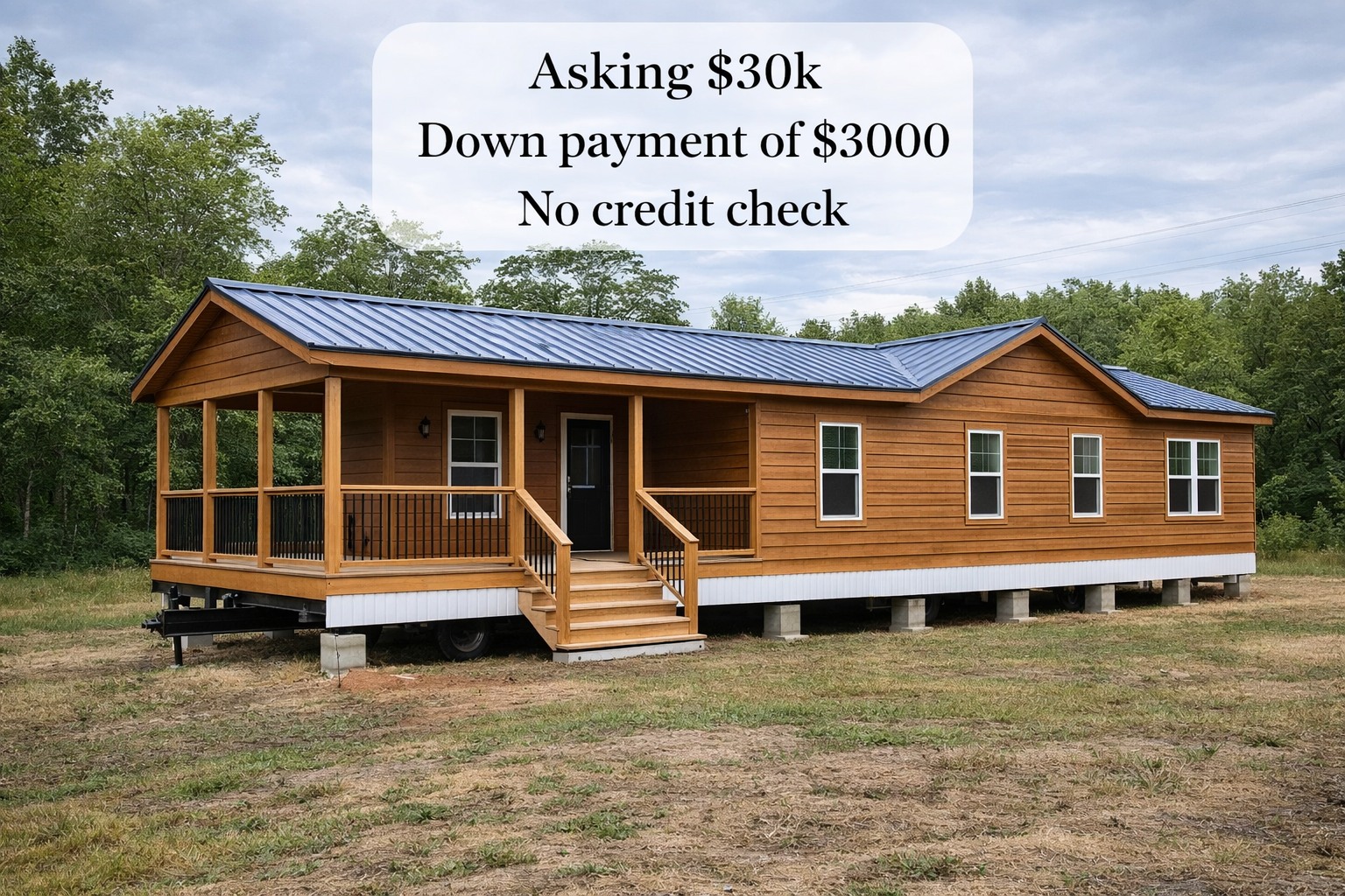 A wooden modular home with a blue metal roof sits elevated in a clearing surrounded by trees. Text overlay: "Asking $30k, Down payment $3000, No credit check."
