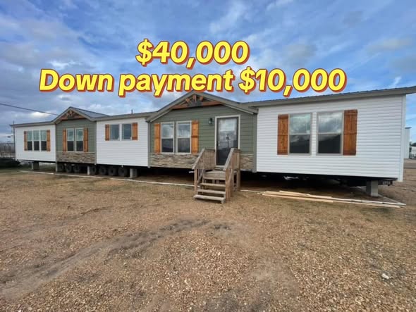 A modular home on a gravel lot with blue sky. Text reads "$40,000 Down payment $10,000" in bold yellow, conveying a sales offer.