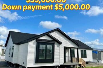 White house with black trim under blue skies. Price text: "$35,000.00, Down payment $5,000.00." Grass in foreground, welcoming tone.
