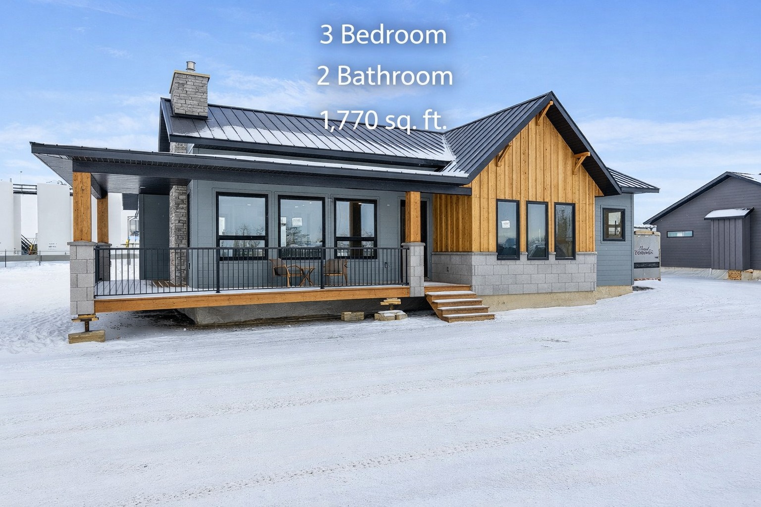 Modern single-story house with stone and wood siding, large windows, and a covered porch, labeled "3 Bedroom, 2 Bathroom, 1,770 sq. ft." on a snowy terrain.