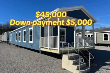 A blue manufactured home with a small covered porch and metal stairs, set on gravel. Text overlay indicates "$45,000" and "Down payment $5,000."