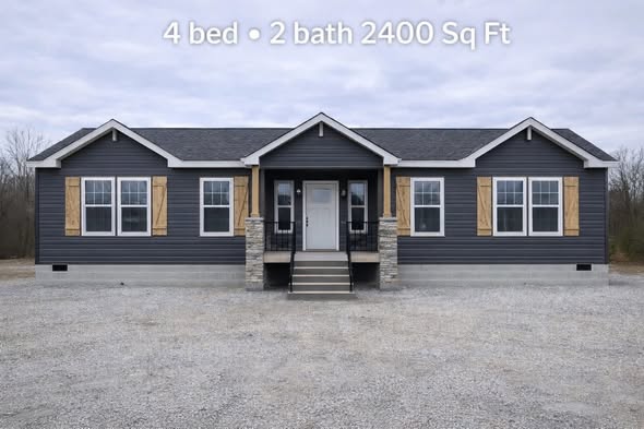 Gray single-story house with stone accents and wooden shutters, featuring four beds and two baths, 2400 sq ft. Overcast sky, gravel yard.