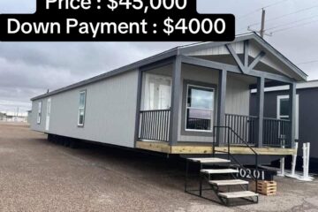 A gray modular home with a small front porch and stairs, set on a gravel lot. Text above shows price $45,000, down payment $4,000. Overcast sky.